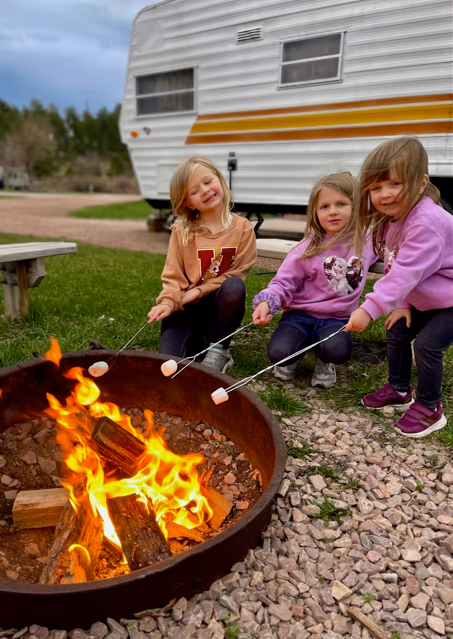 The girls making smores at a KOA Kampground
