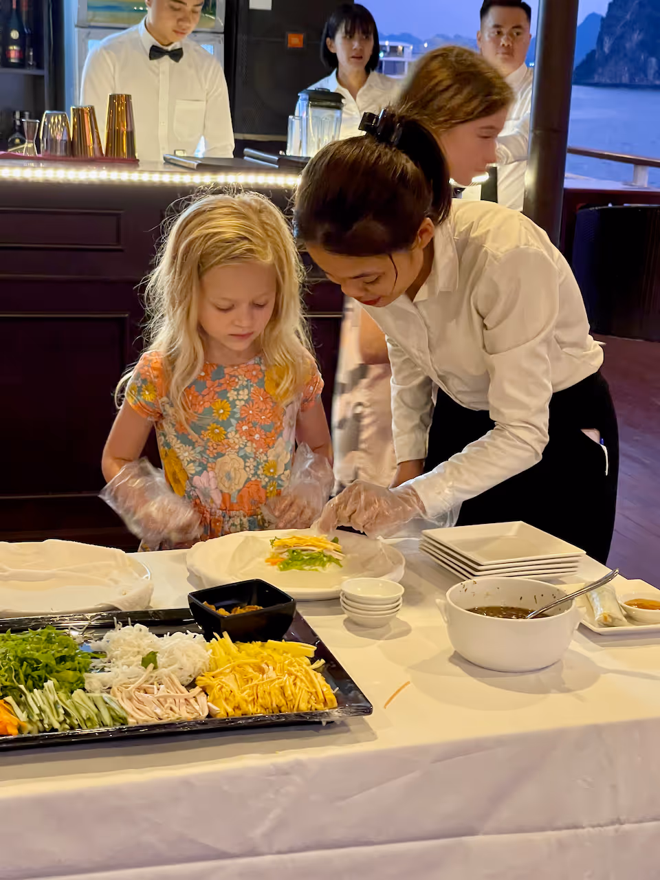 Lily learns to make spring rolls on a cruise in Ha Long Bay
