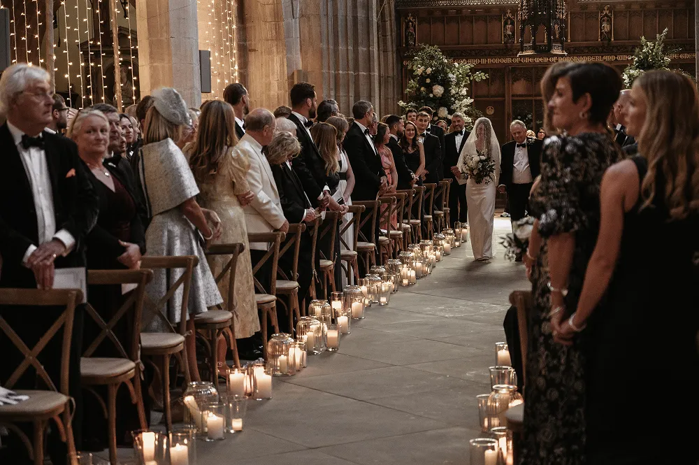 wedding reception lined with candles - bride and father walking down