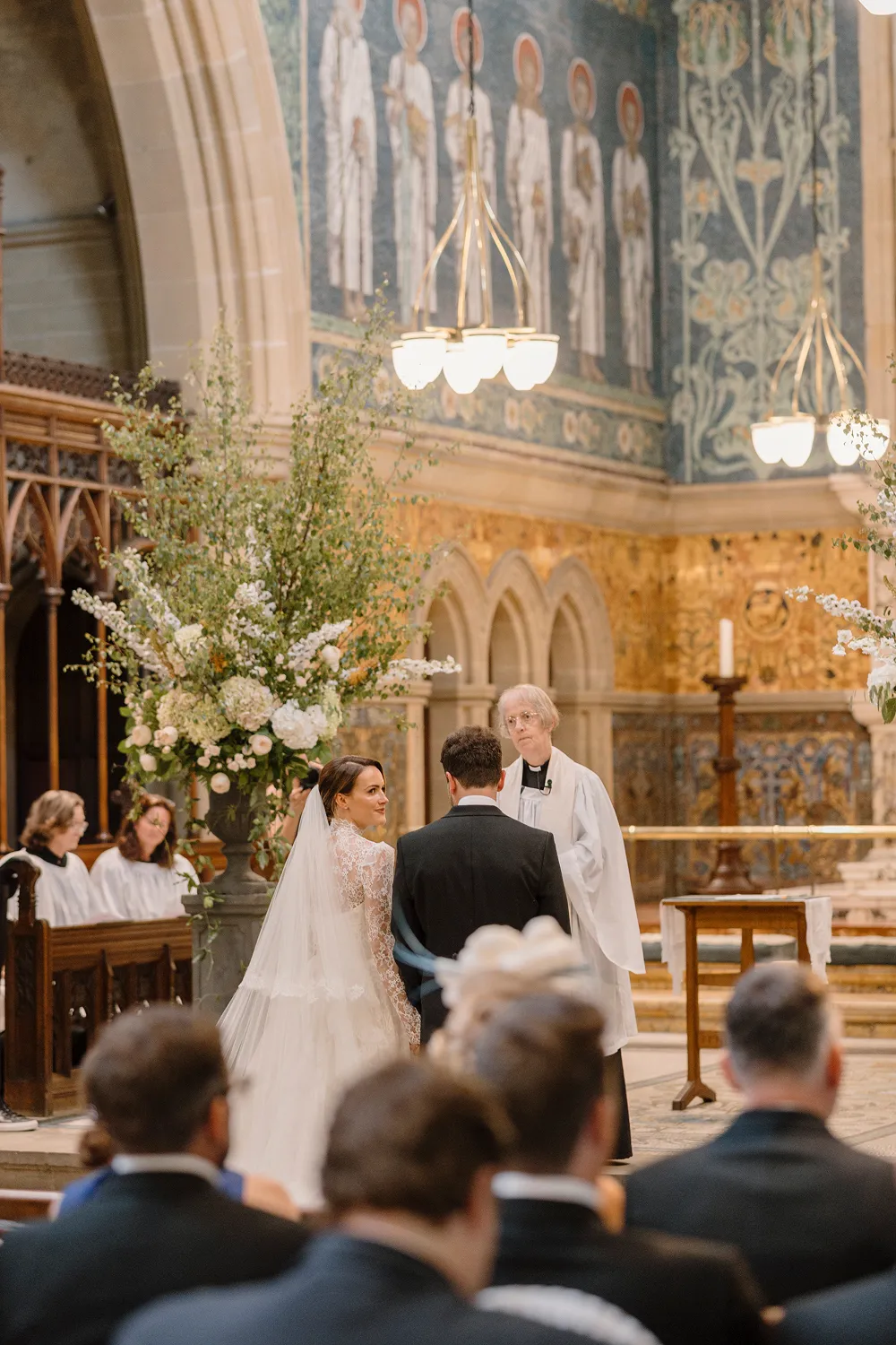 wedding ceremony with large scale flower design at the church alter
