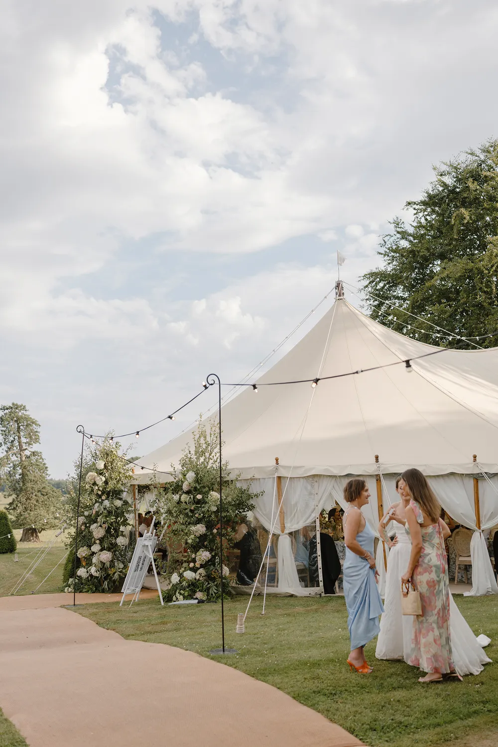 wedding marquee with floral displays at the entrance