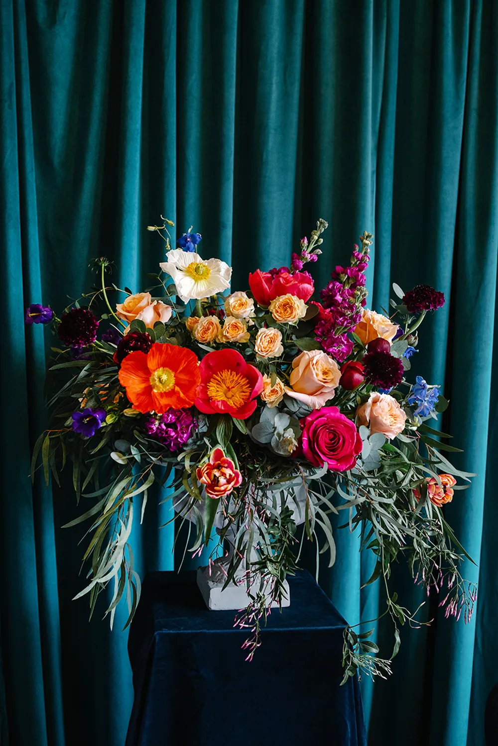 bright flowers on pedestal at a wedding