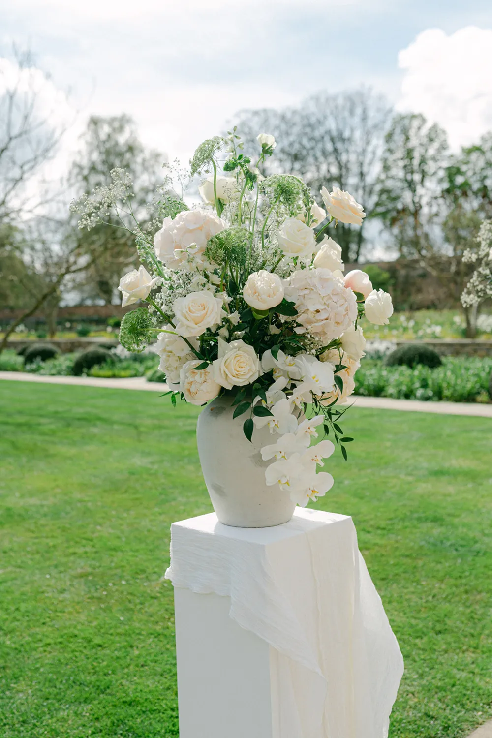 white flowers on pedestal at a wedding