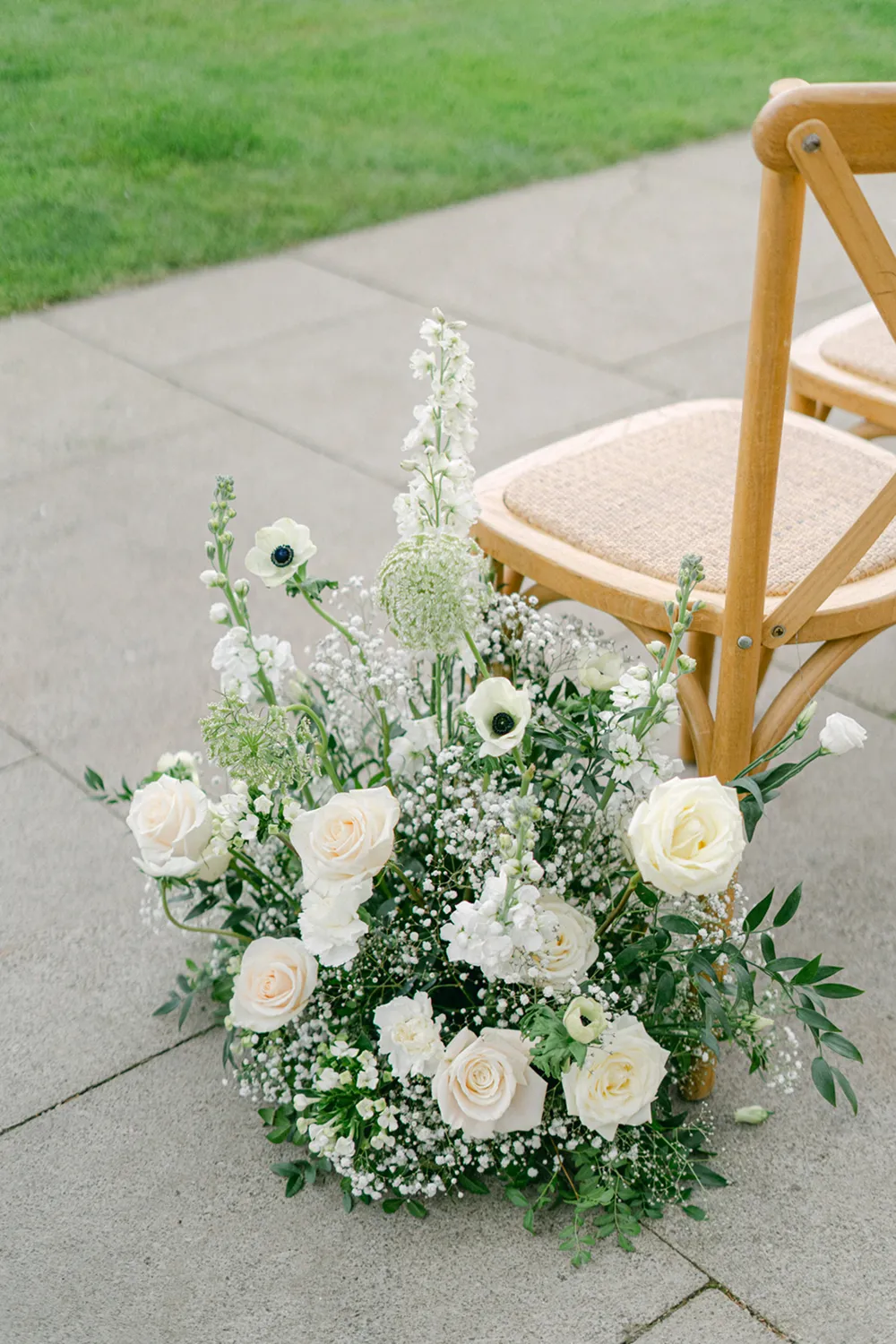 flowers next to seats at wedding ceremony