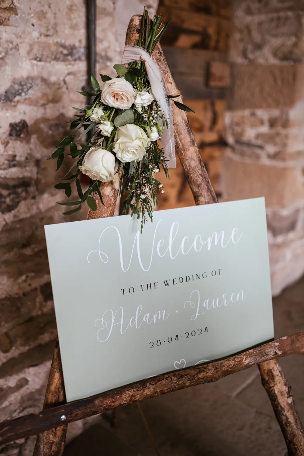 wedding welcome sign with floral arrangement
