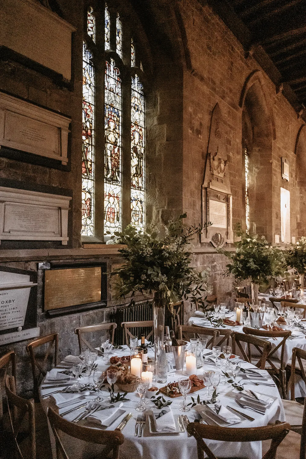 tall floral centrepiece on round tables