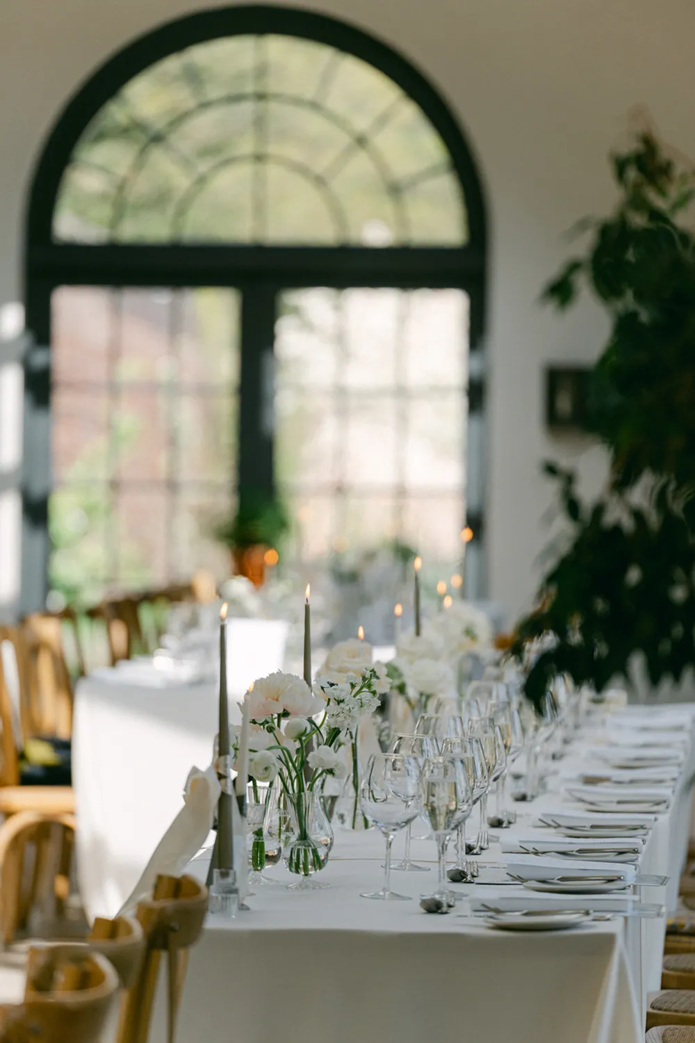 long wedding tables decorated with flowers and candles