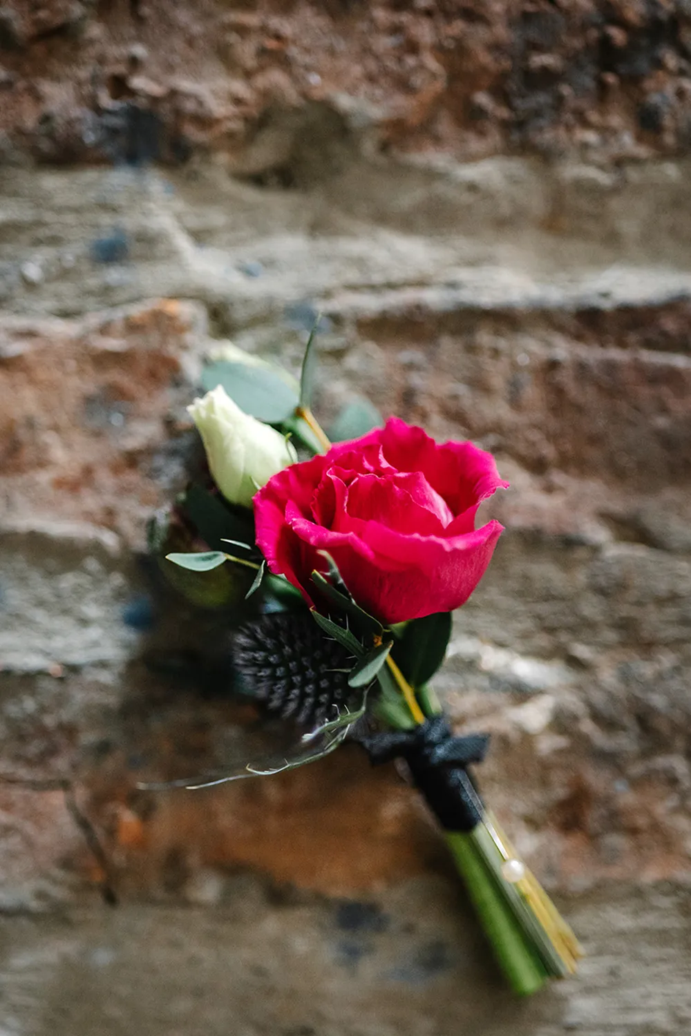 pink buttonhole lying on table