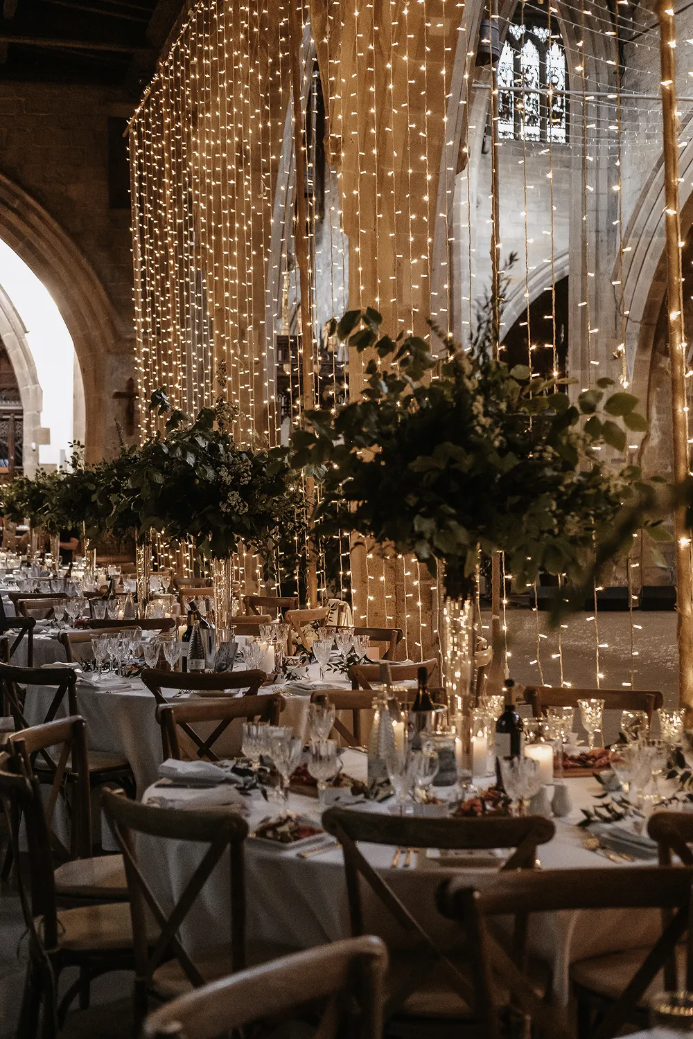 wedding breakfast decoration with lights and tall centrepieces