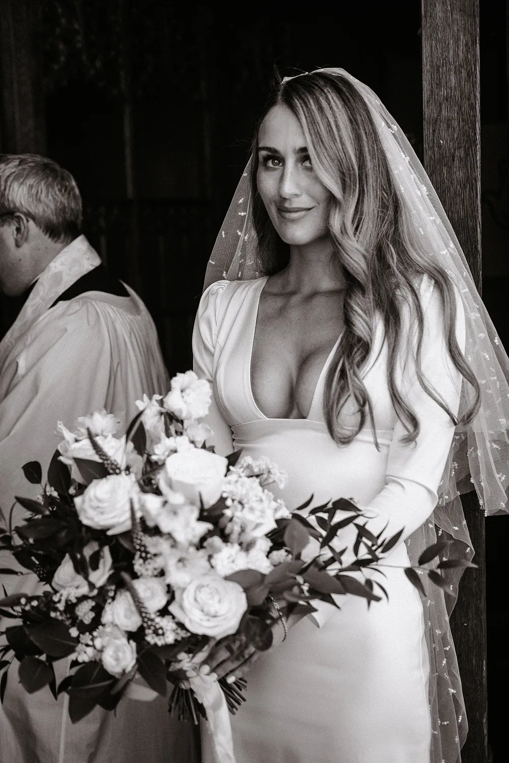 bride holding rust orange wedding bouquet
