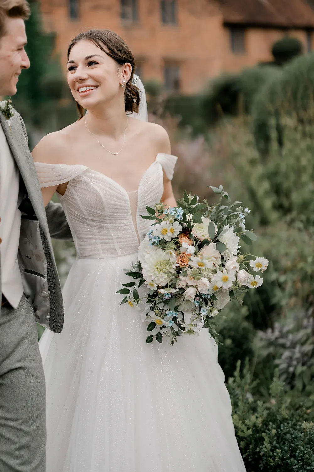 bride holding rust orange wedding bouquet