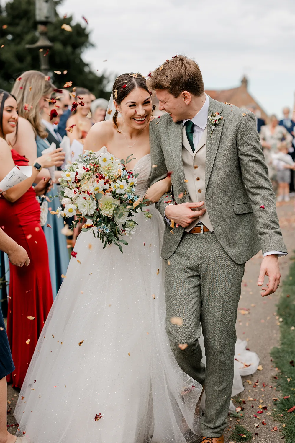 bride holding rust orange wedding bouquet