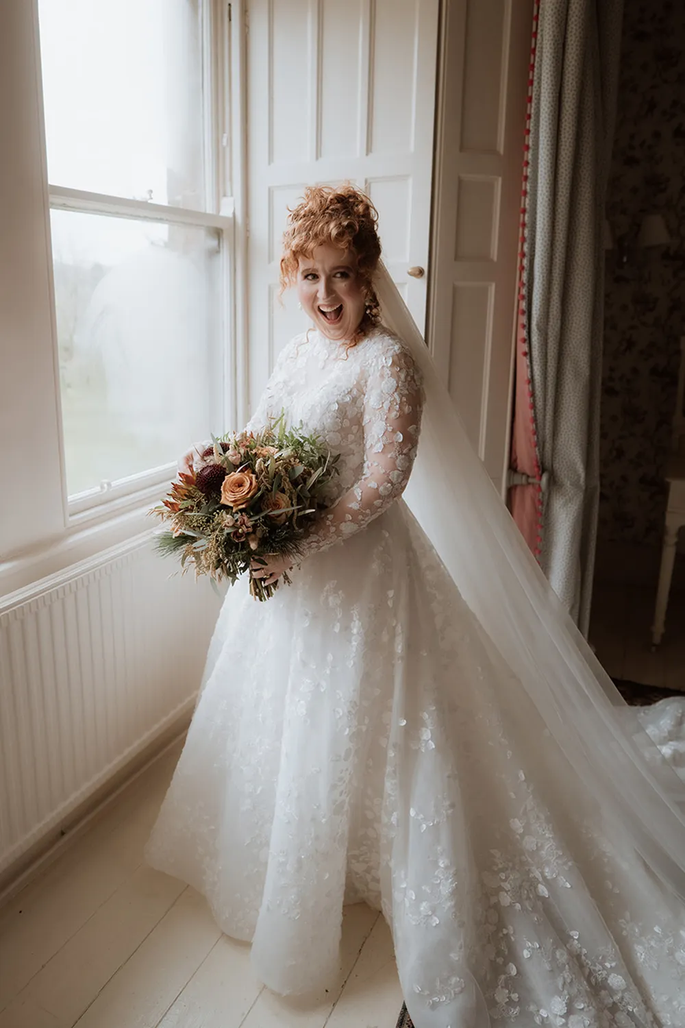 bride holding rust orange wedding bouquet