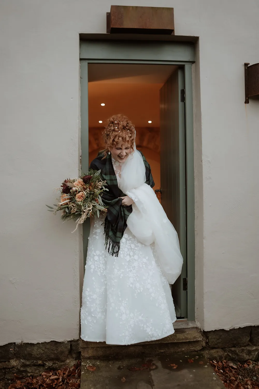 bride holding rust orange wedding bouquet