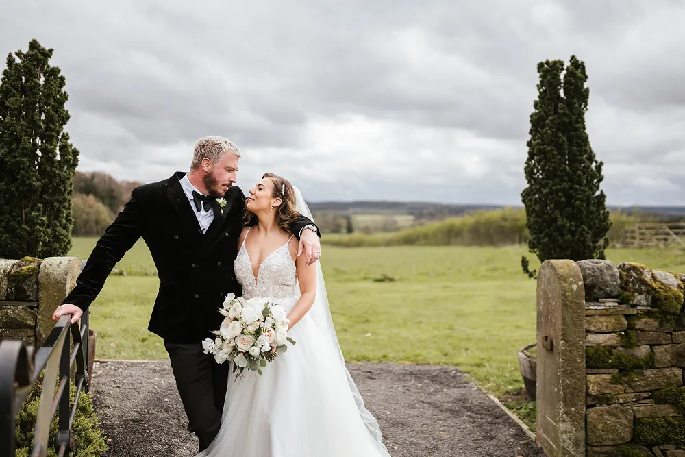bride holding rust orange wedding bouquet