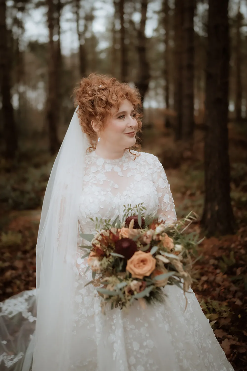 bride holding rust orange wedding bouquet