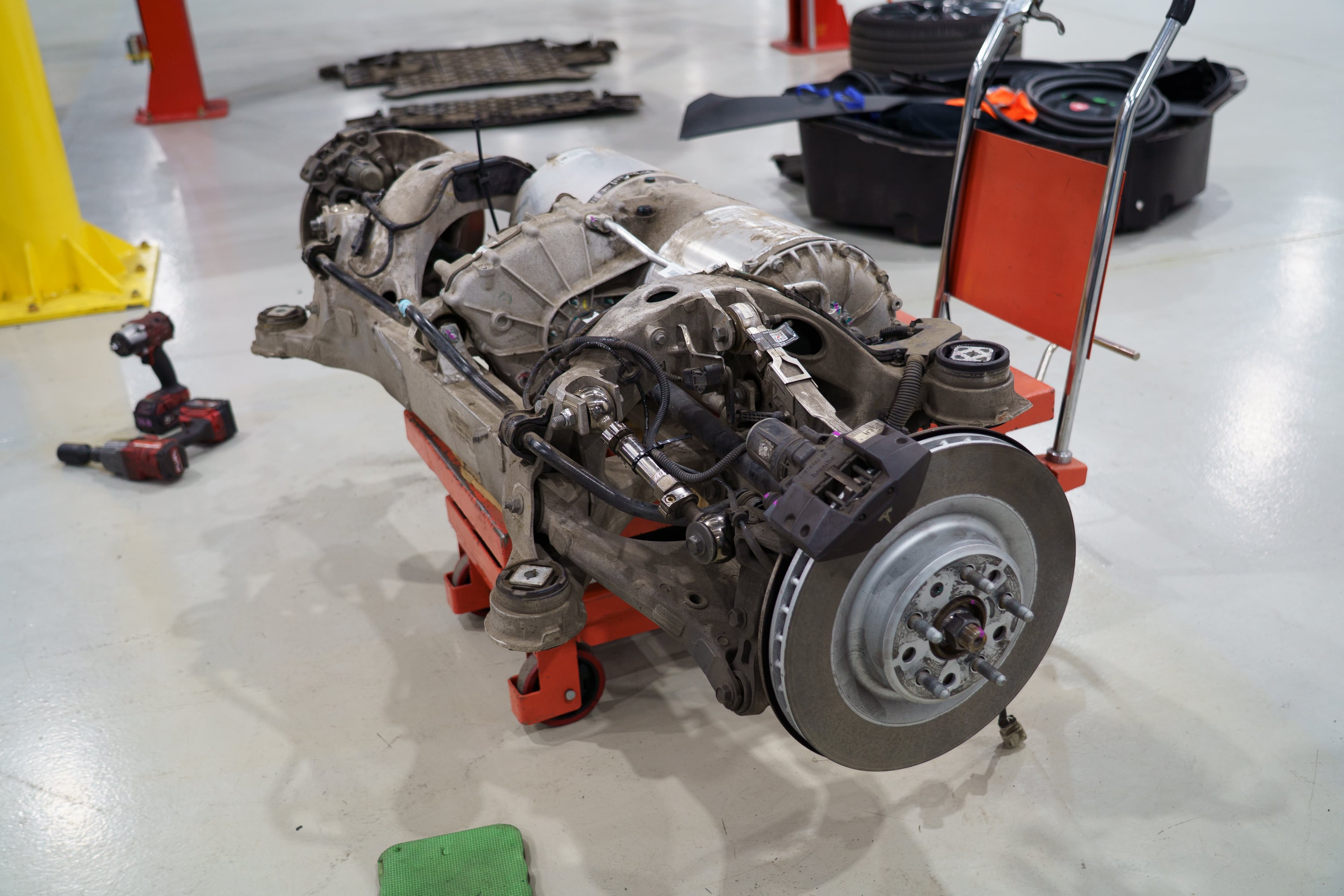 Tesla rear subframe and drive unit removed, ready for teardown