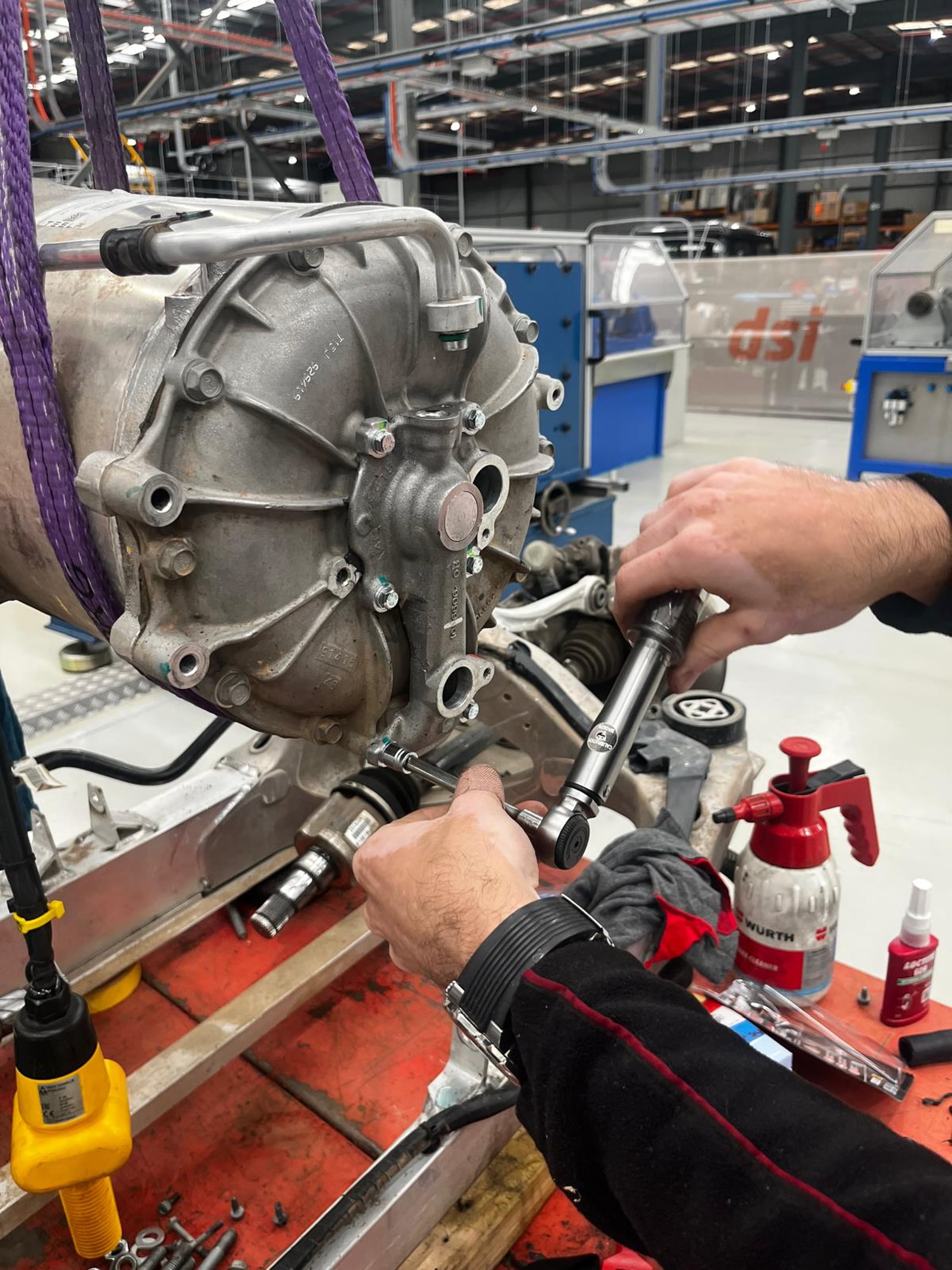 Technician reassembling drive unit by hand