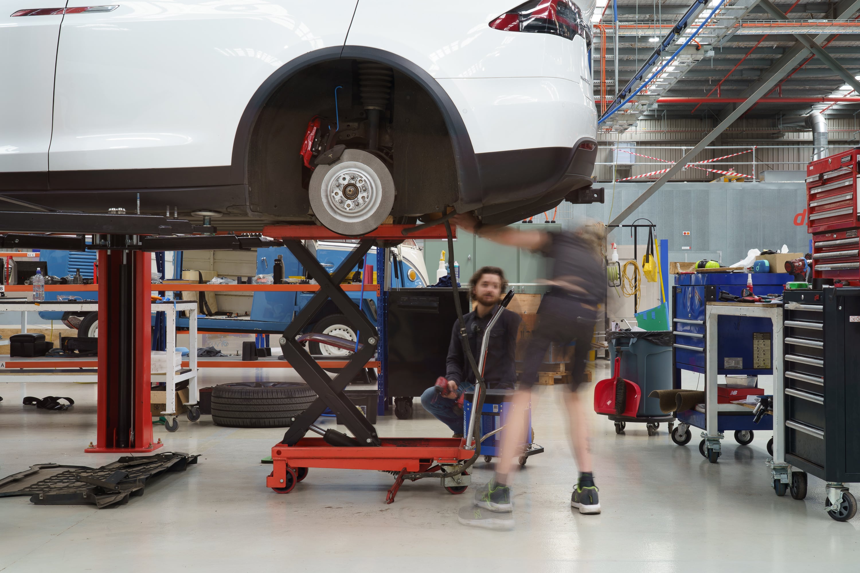 Jaunt team removing the rear subframe and drive unit from a Tesla Model X