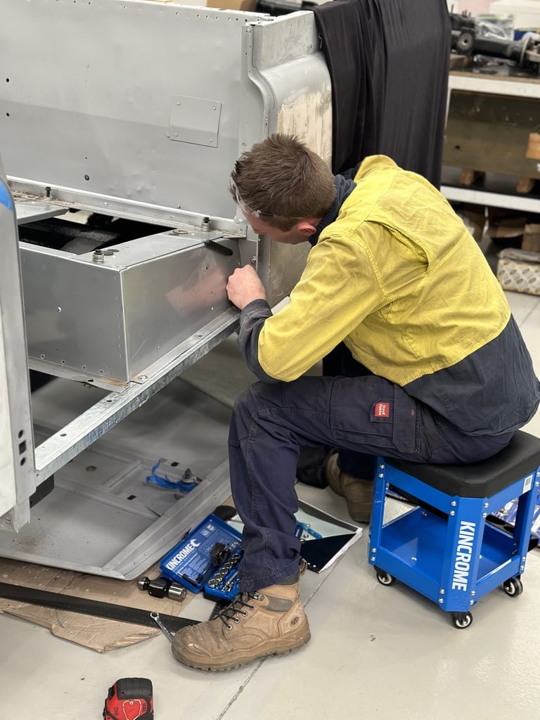Technician fitting body panels during the Series 2a build