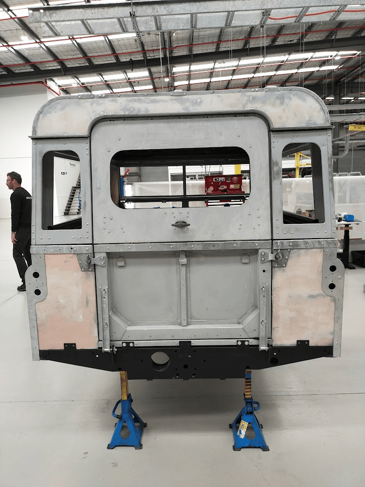 Bare body shell from rear showing custom hardtop construction