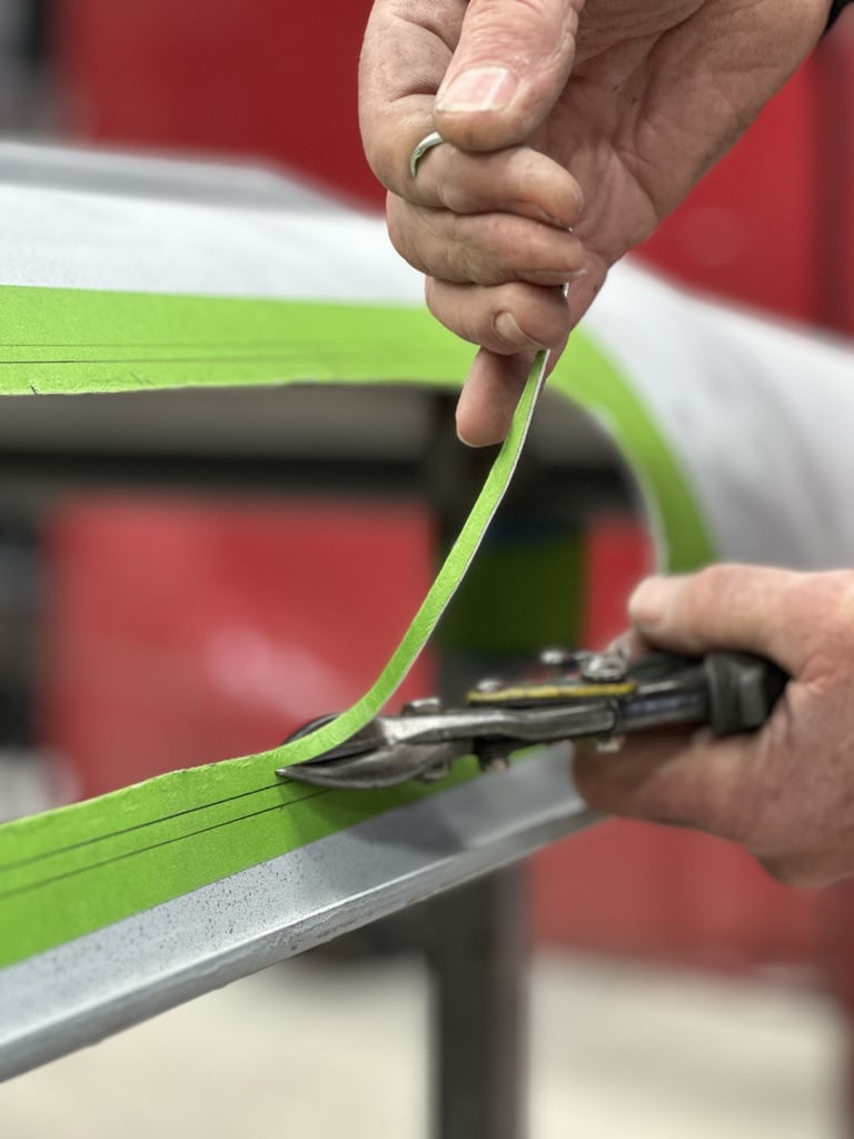Panel stripe detail with metalworking tools during body fabrication