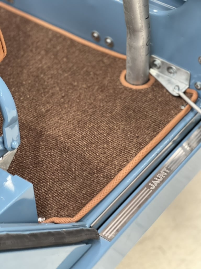 Custom carpet with leather edging and Jaunt sill plate