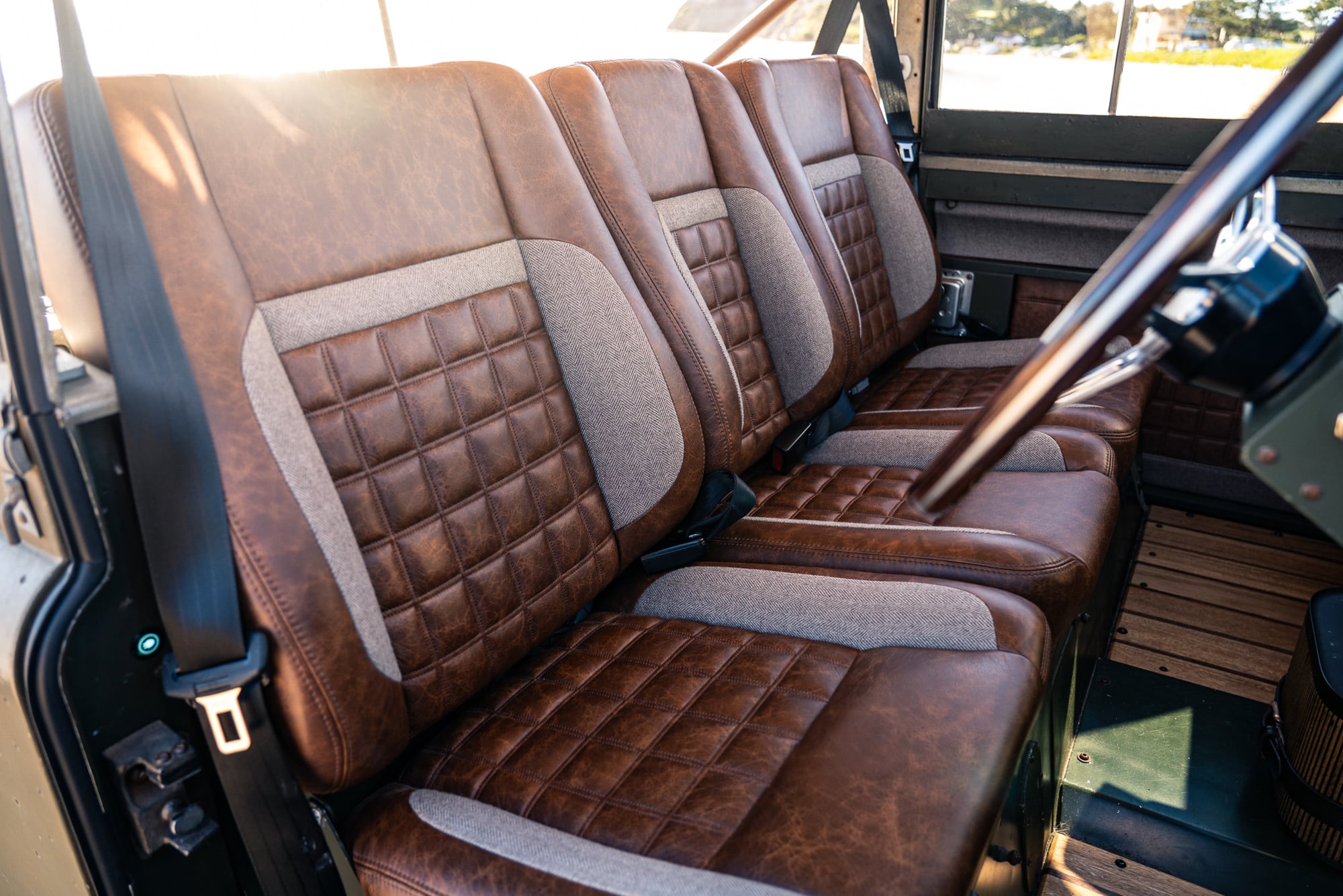 Quilted leather and tweed front seats in a Jaunt electric Land Rover