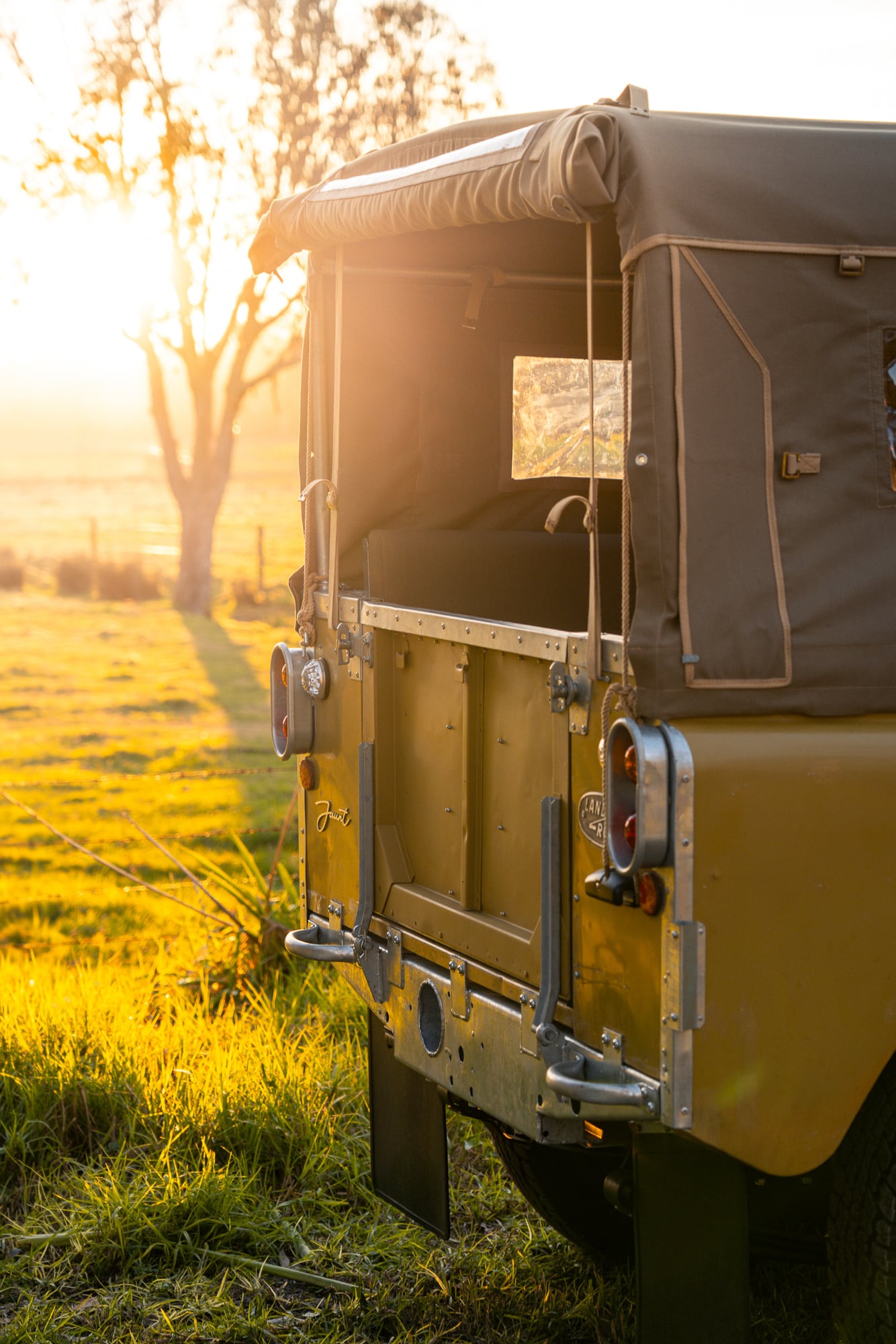 Rear view of the green Series 2a at golden hour with tailgate open