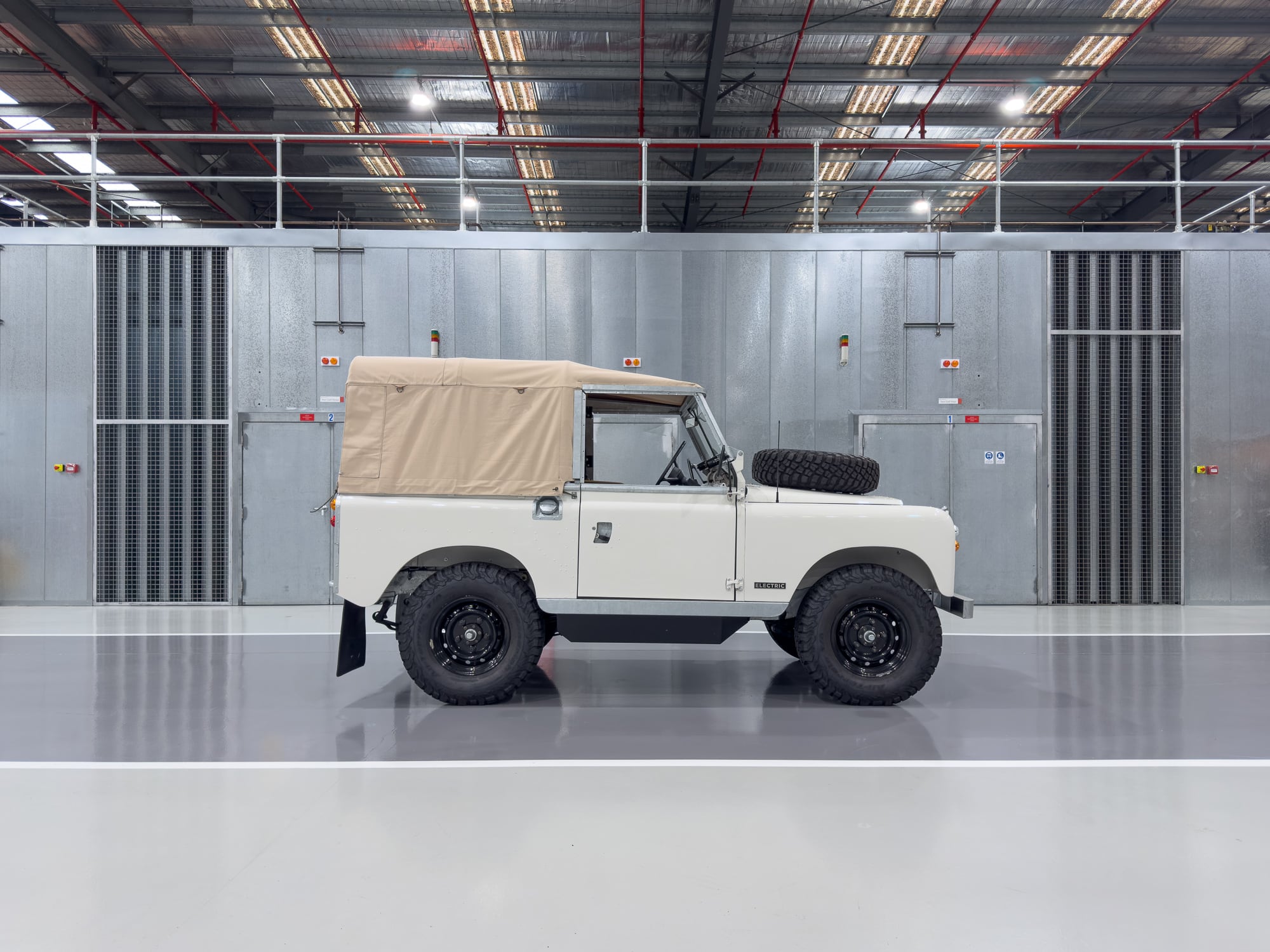 White electric Land Rover Series 2a — full side profile in studio