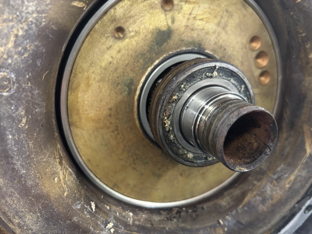 Corroded rotor bearing with displaced grease on a coolant-damaged Tesla drive unit