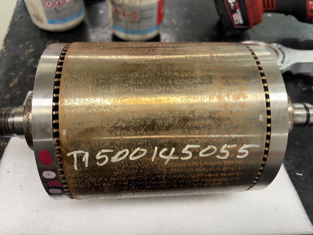 Corrosion smeared around the outer surface of a Tesla LDU rotor from coolant contamination