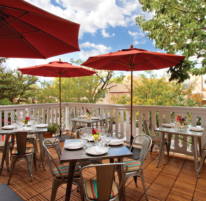 El Rincon patio with tables, chairs and umbrellas
