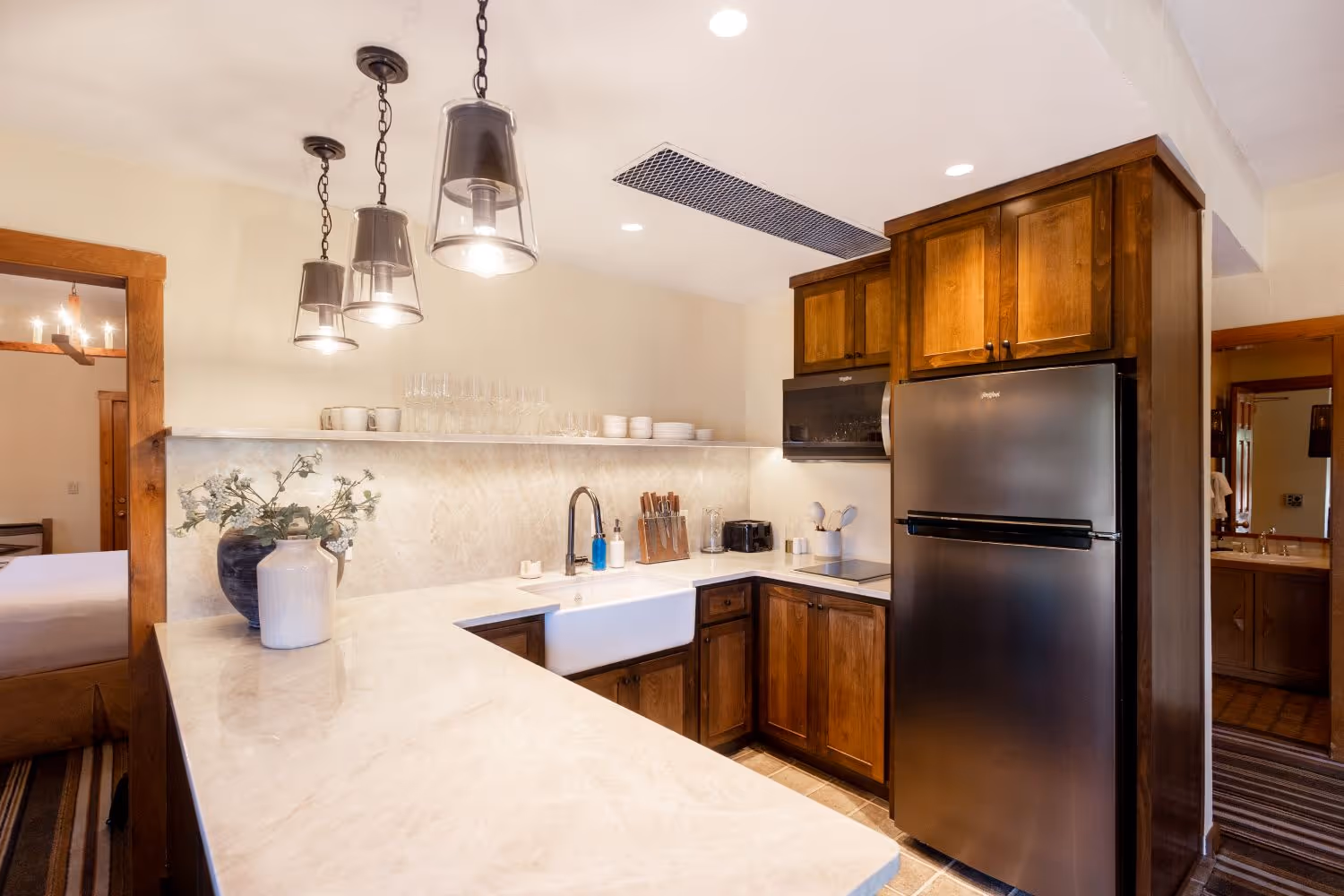 Kitchen in Presidential Suite with whit marble island and fridge