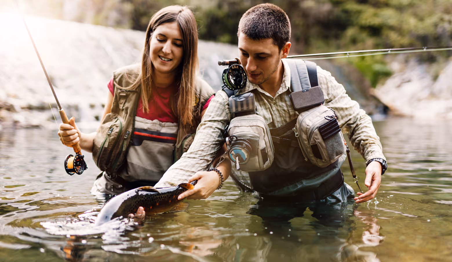 Two people fly fishing in a river
