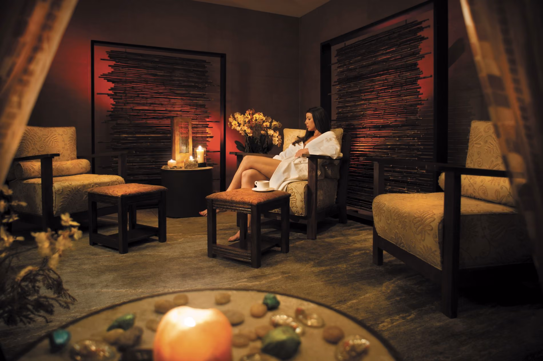 Woman in a robe sitting in Nidah Spa's wa