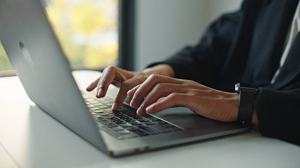person typing on a laptop