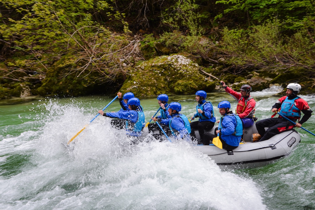 rafters splash through a whitewater rapid in bled