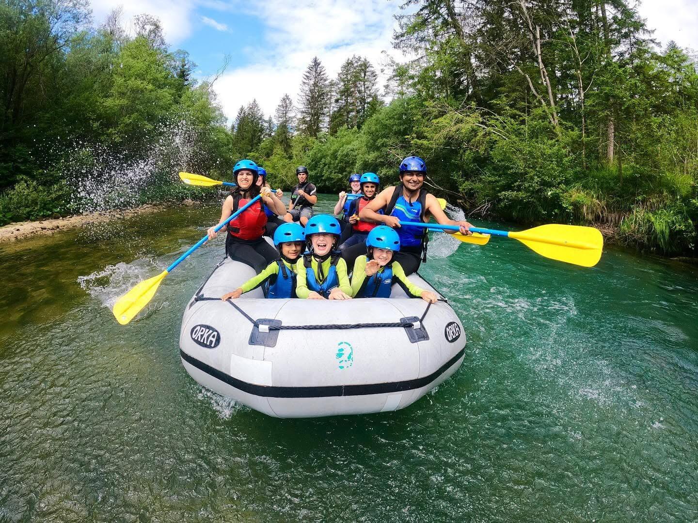 Family group white water rafting on the Sava Dolinka river in Bled, Slovenia