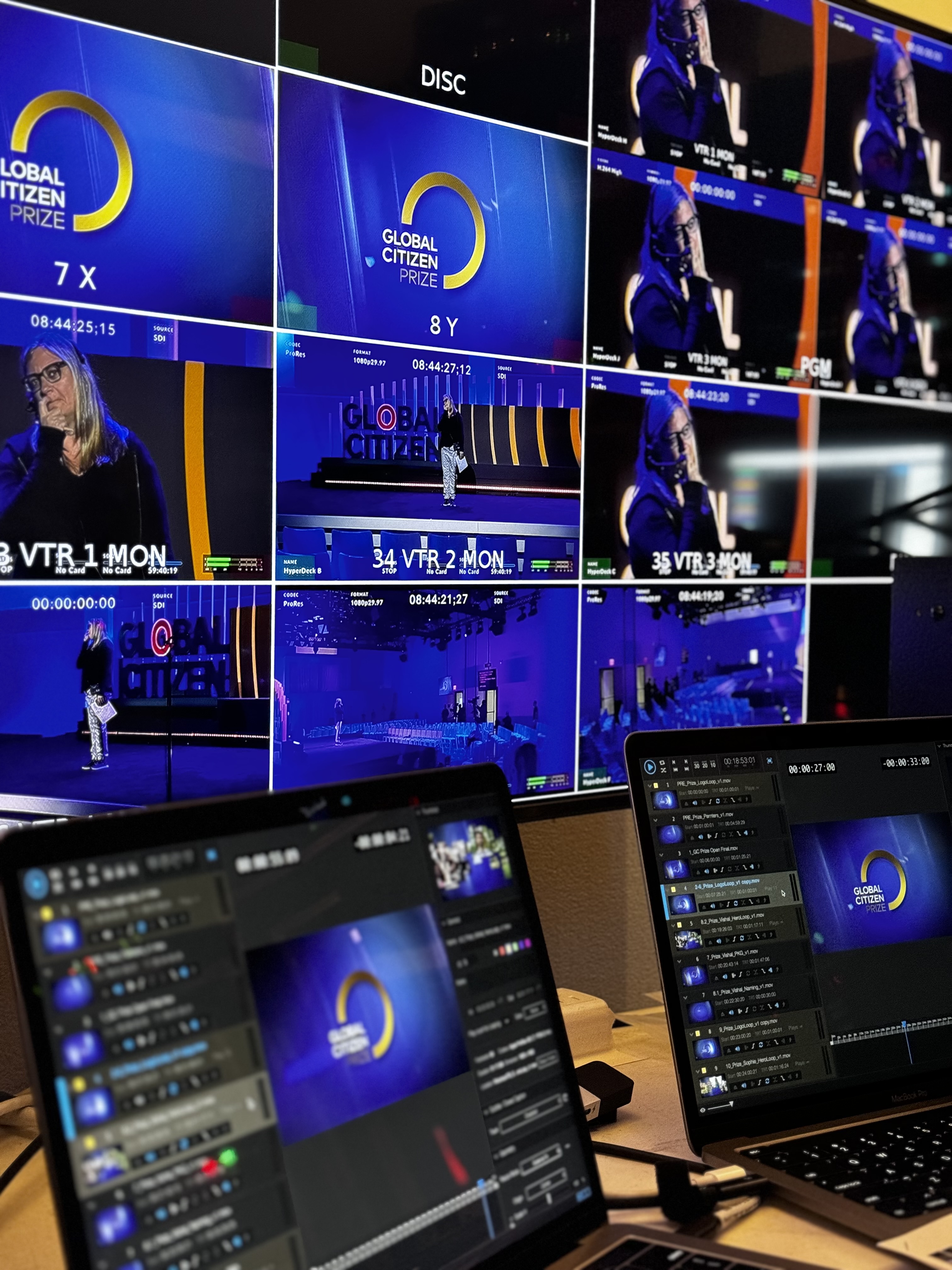 Live production control screens and playback laptops managed behind the scenes