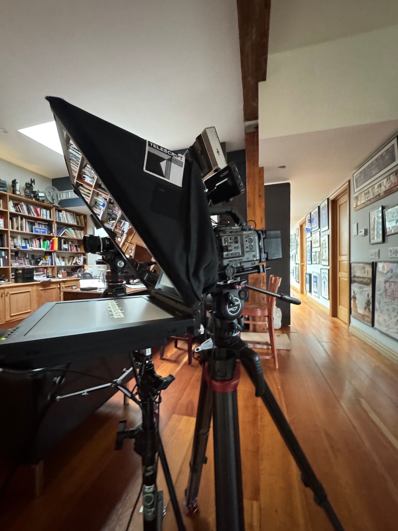 Compact lightweight teleprompter mounted to a camera in a small production setting