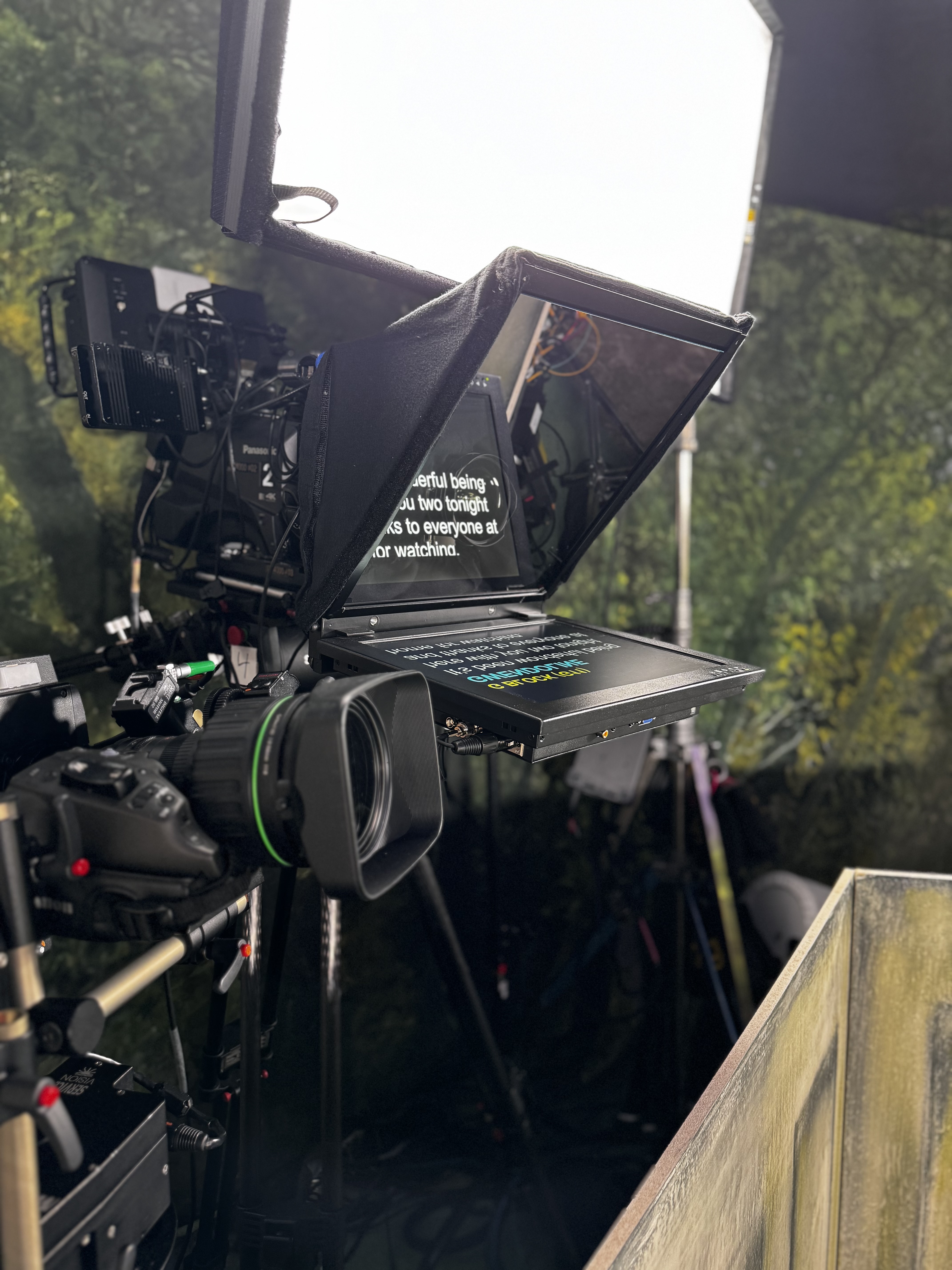 Professional on-camera teleprompter mounted directly in front of a cinema camera