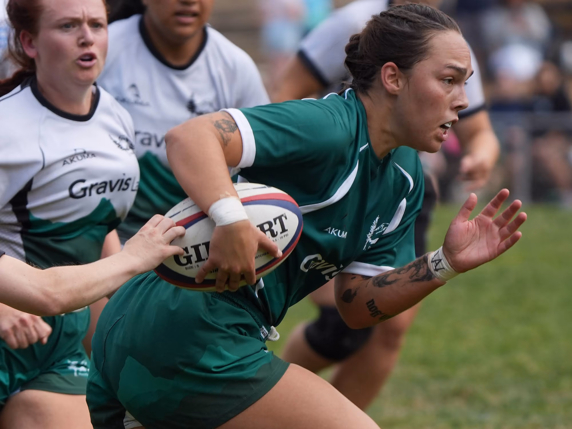 Rugby player in blue and white jersey running with ball while another player in yellow tries to tackle.