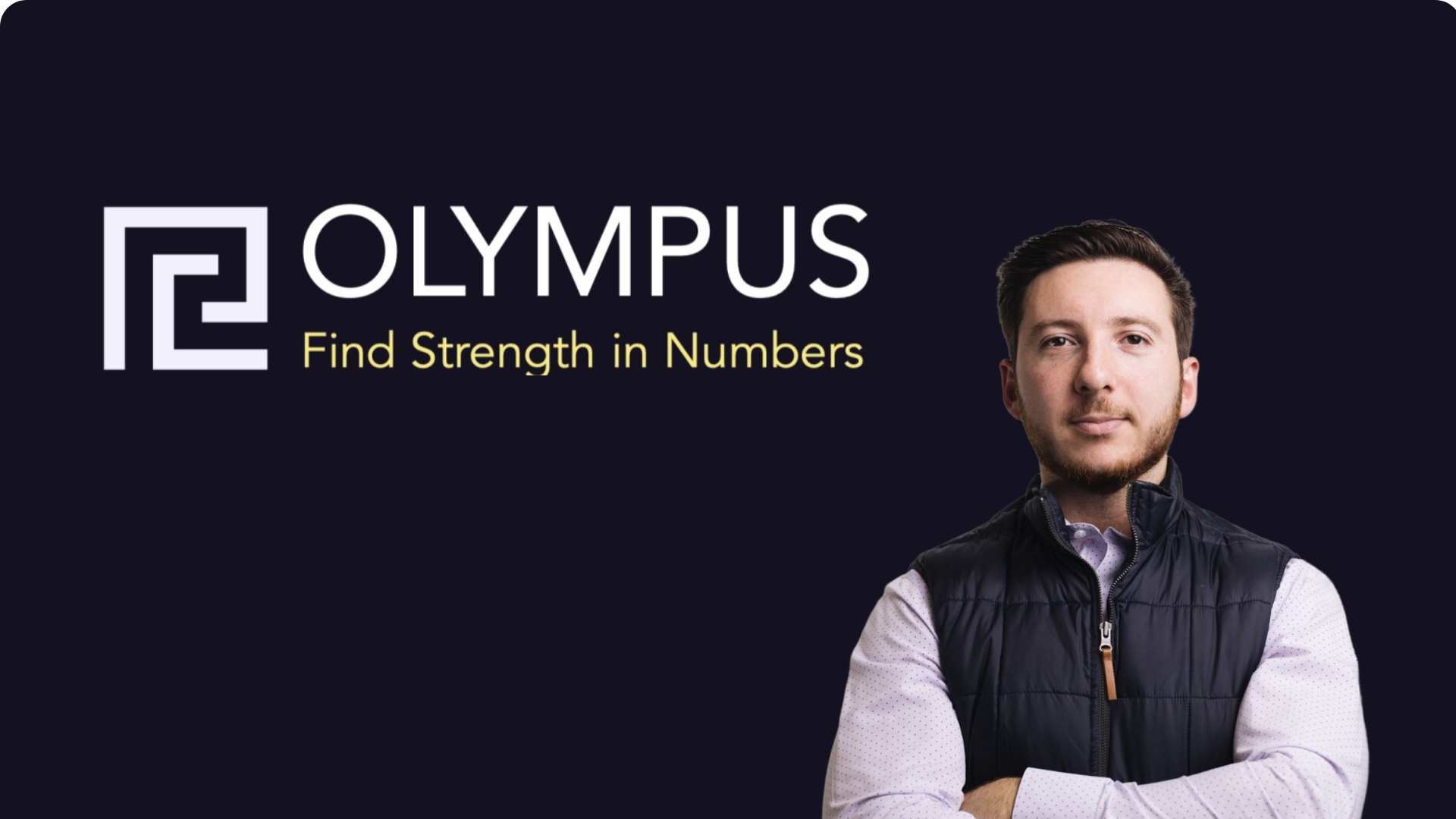 Scott stands with arms crossed in front of a black background.