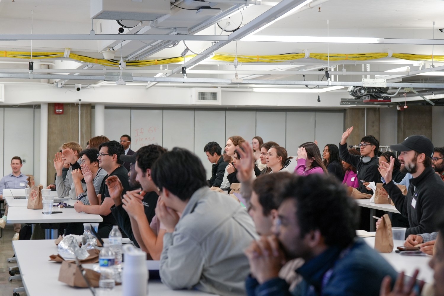 Students raising their hands at the Problem Summit
