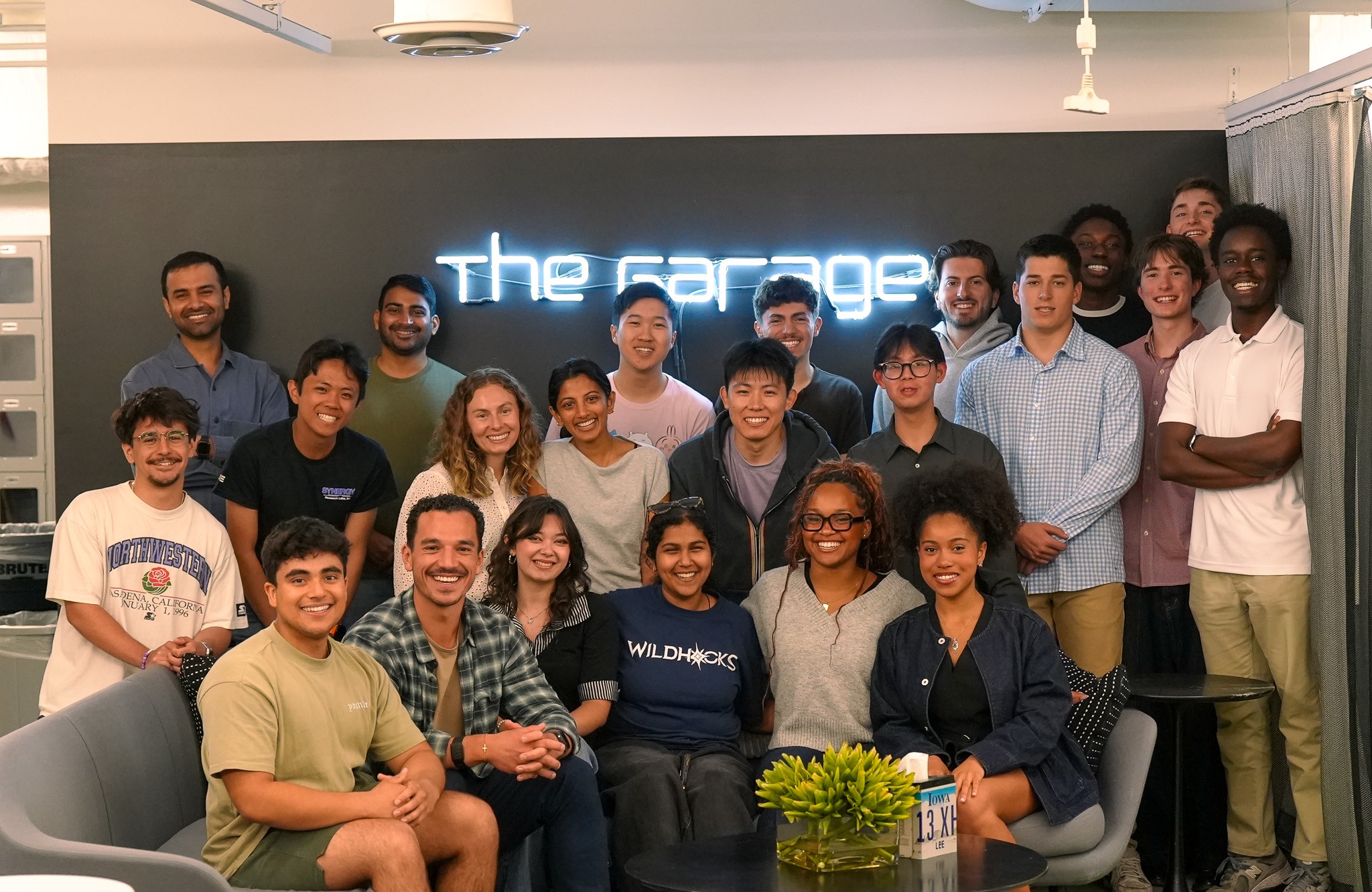 The Jumpstart 2026 cohort standing under the neon Garage sign.