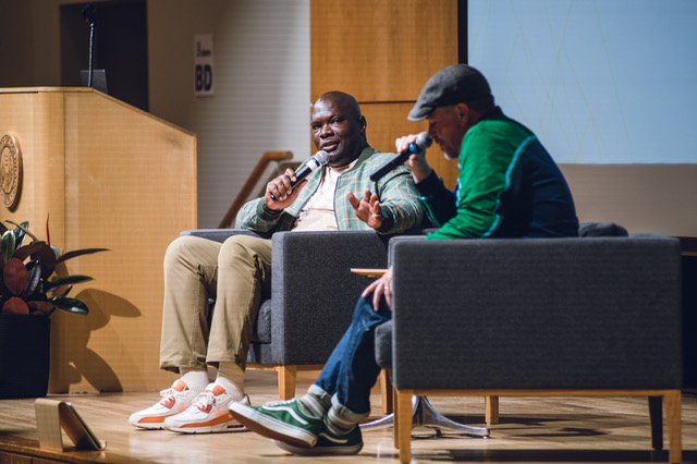 Clarence on stage holding a microphone