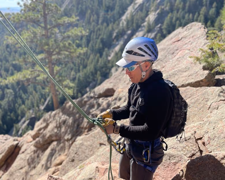 Photo of older man getting ready to rock climb