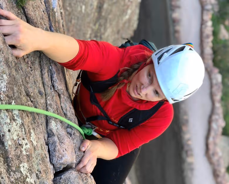 Photo of woman focusing during a rock climb