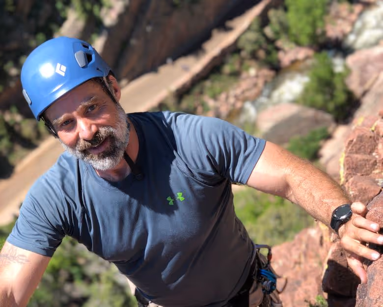 Photo of older gentleman rock climbing in Boulder